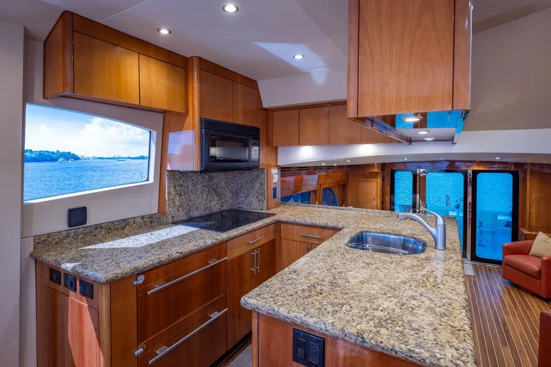 Starka Yacht Photos Pics Luxurious kitchen interior of 2009 Hatteras 64 Motor Yacht with granite countertops and ocean view.