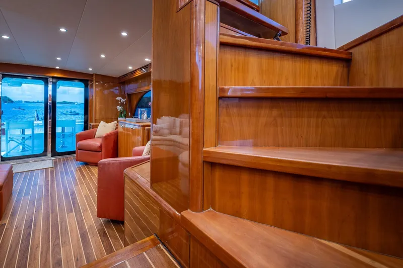 Starka Yacht Photos Pics Luxurious interior of 2009 Hatteras 64 Motor Yacht with wooden stairs and ocean view.