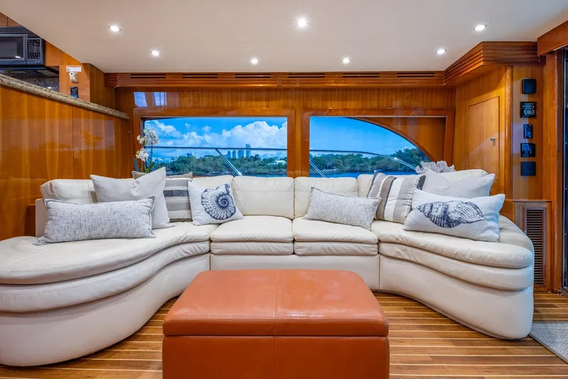 Starka Yacht Photos Pics Luxurious interior of 2009 Hatteras 64 Motor Yacht with plush seating and scenic window view.