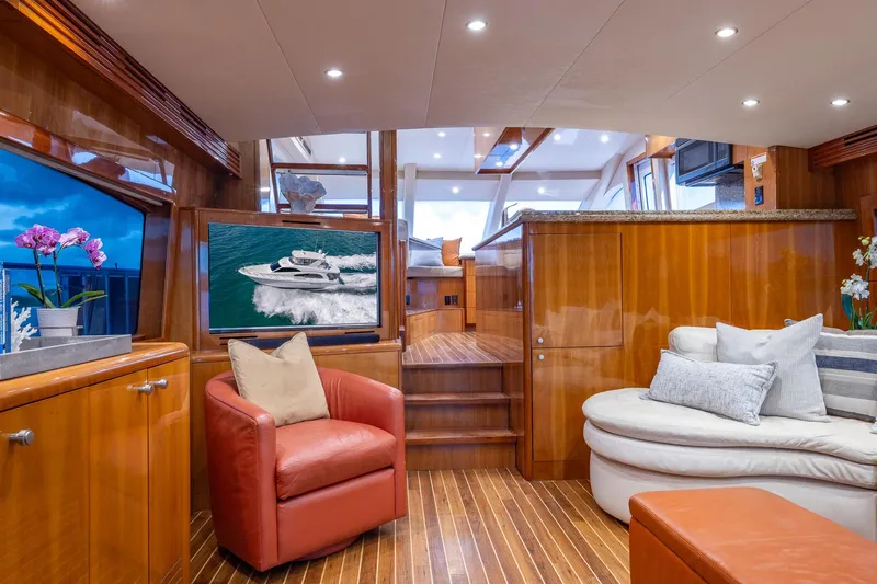 Starka Yacht Photos Pics Luxurious interior of 2009 Hatteras 64 Motor Yacht with elegant wood finishes and plush seating.