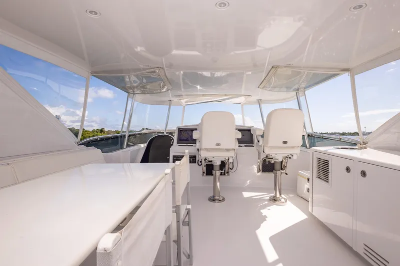 Starka Yacht Photos Pics 2009 Hatteras 64 Motor Yacht helm with white seating and panoramic windows.