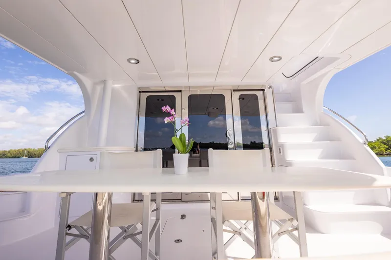 Starka Yacht Photos Pics Luxurious 2009 Hatteras 64 Motor Yacht deck with elegant seating and scenic water view.