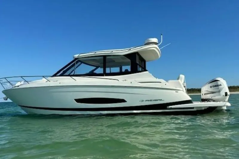  Yacht Photos Pics 2021 Regal 36 XO boat on water, side view, clear blue sky.
