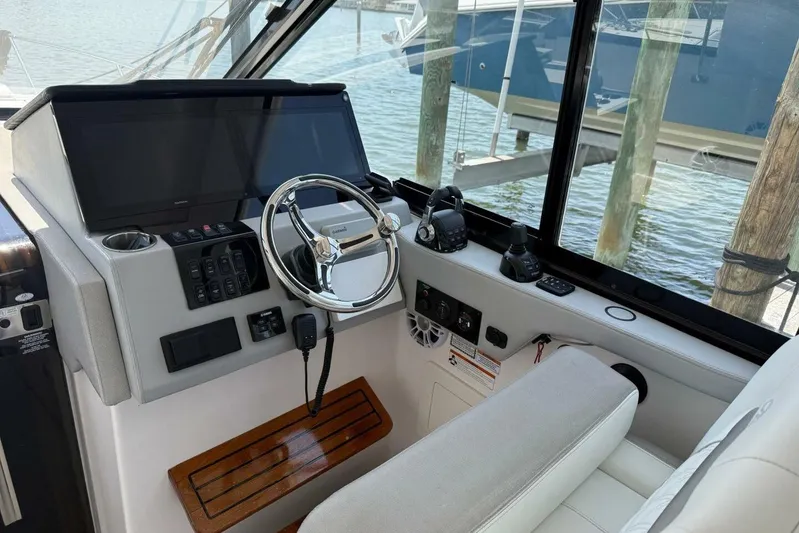  Yacht Photos Pics 2021 Regal 36 XO boat helm with steering wheel and navigation controls.