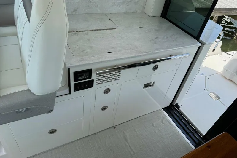  Yacht Photos Pics 2021 Regal 36 XO yacht interior with sleek white cabinetry and seating.