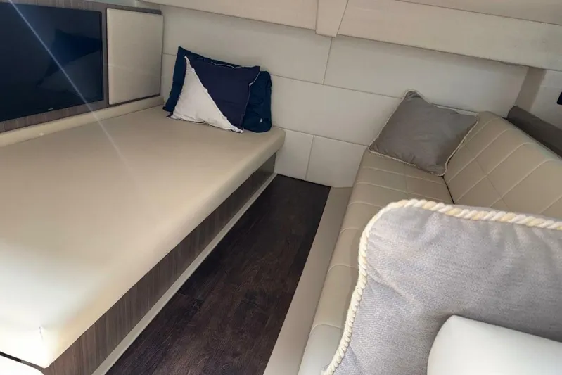  Yacht Photos Pics 2021 Regal 36 XO cabin interior with beige seating and decorative pillows.