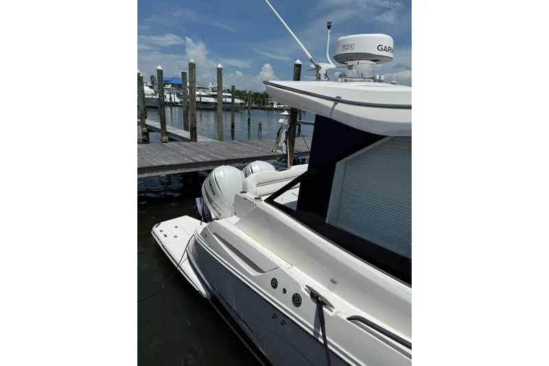  Yacht Photos Pics 2021 Regal 36 XO yacht docked, featuring dual outboard engines and sleek design.