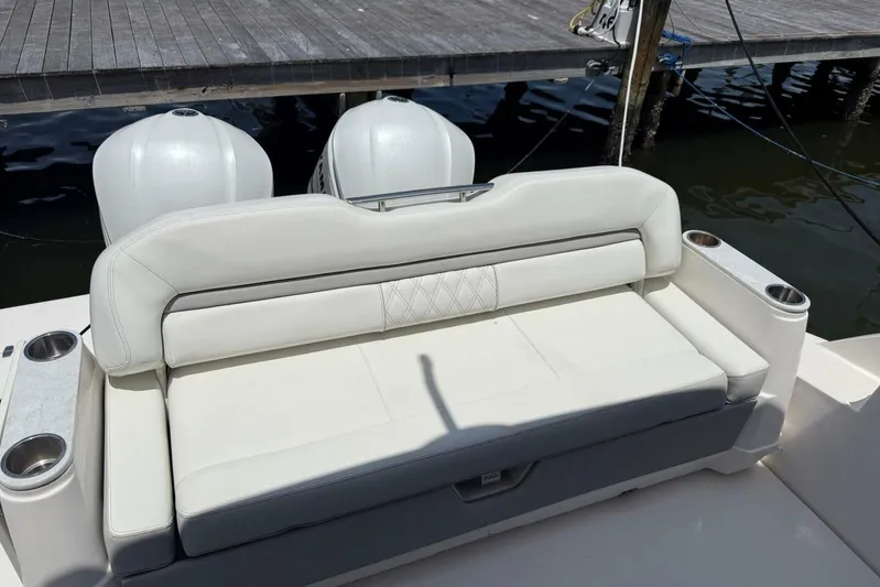  Yacht Photos Pics 2021 Regal 36 XO boat with white cushioned seating and dual outboard motors.