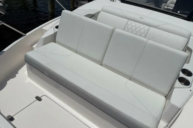  Yacht Photos Pics White seating area on a 2021 Regal 36 XO boat, featuring cup holders.