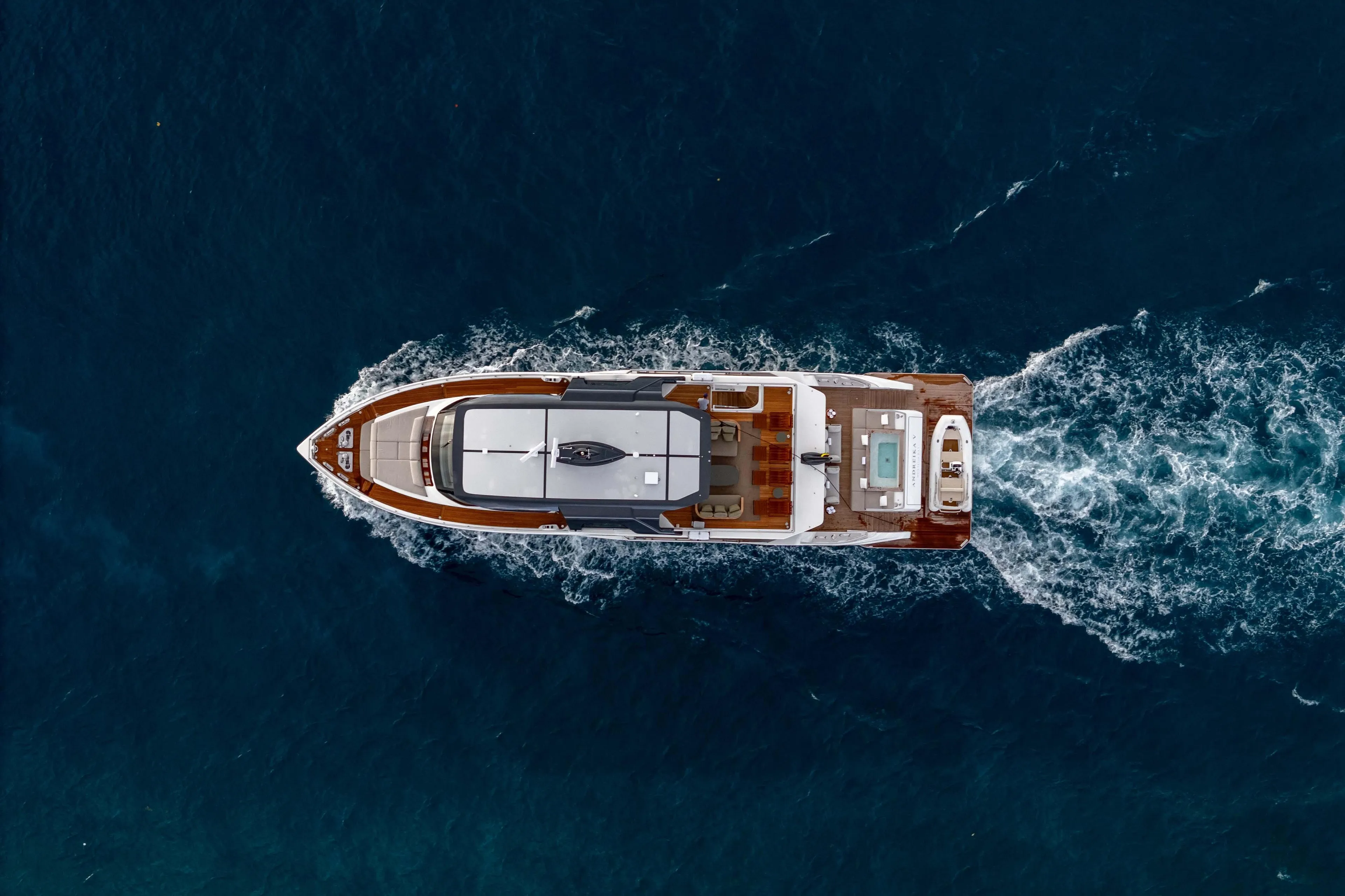 Aerial view of 2025 Alpha Squalo Co Ownership yacht cruising in deep blue ocean.