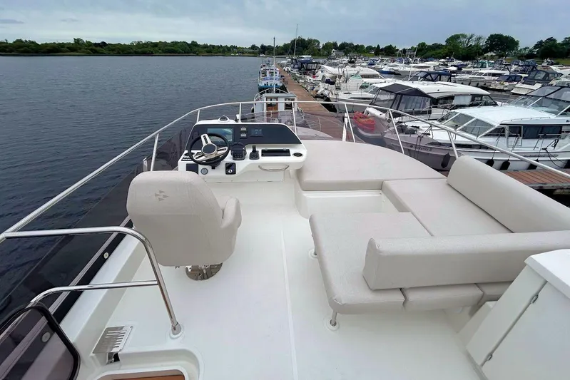  Yacht Photos Pics Luxurious 2025 Prestige F4.9 yacht with spacious deck and modern helm, docked at marina.