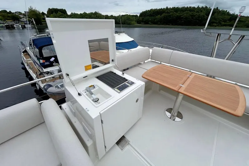  Yacht Photos Pics Luxury Prestige F4.9 yacht deck with grill and wooden table, 2025 model.