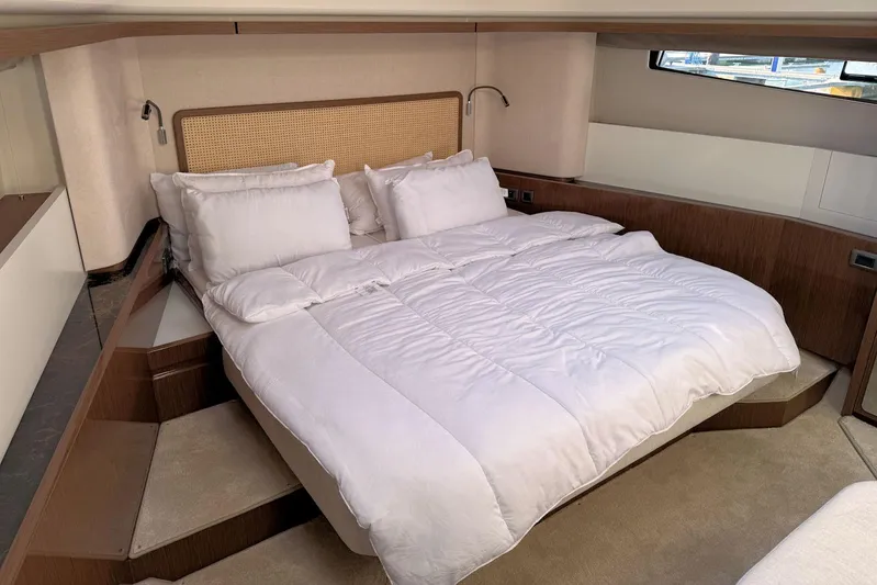  Yacht Photos Pics Luxurious bedroom interior of 2025 Prestige F4.9 yacht with plush bedding.