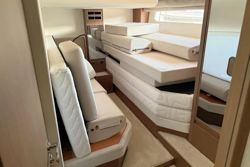  Yacht Photos Pics Luxurious interior of 2025 Prestige F4.9 yacht with stacked mattresses and modern design.