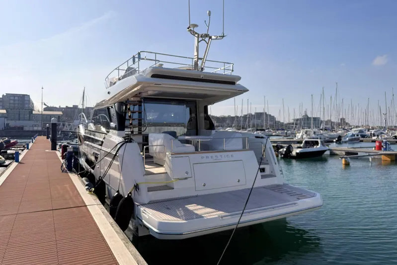  Yacht Photos Pics Luxury 2025 Prestige F4.9 yacht docked at marina under clear blue sky.
