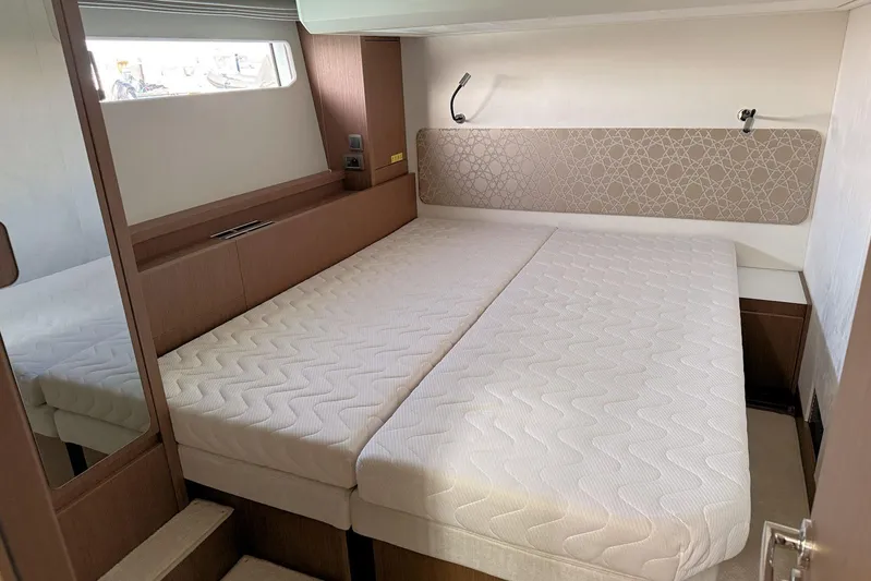  Yacht Photos Pics Modern bedroom interior in 2025 Prestige F4.9 yacht, featuring a comfortable double bed.