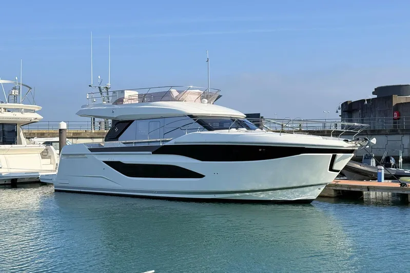  Yacht Photos Pics 2025 Prestige F4.9 yacht docked in marina, showcasing sleek design and modern features.