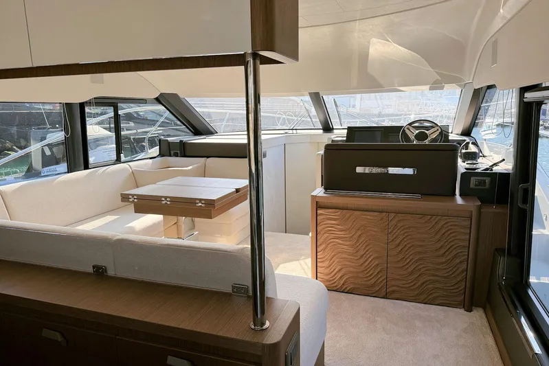  Yacht Photos Pics Luxurious interior of 2025 Prestige F4.9 yacht with elegant seating and modern helm.