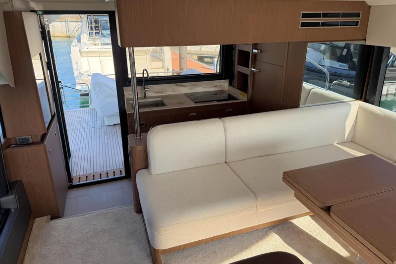  Yacht Photos Pics Luxurious interior of 2025 Prestige F4.9 yacht with modern seating and kitchenette.