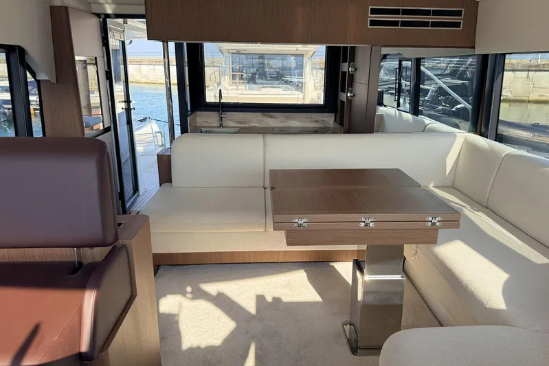  Yacht Photos Pics Luxurious interior of 2025 Prestige F4.9 yacht with elegant seating and wooden table.