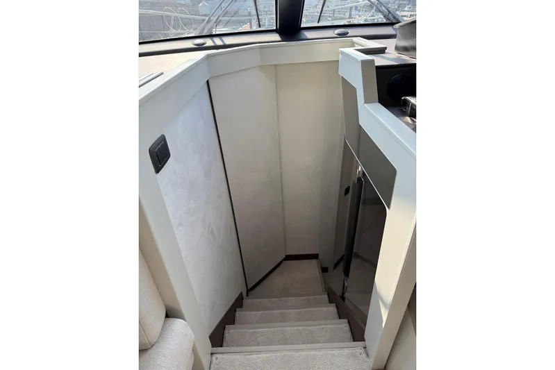  Yacht Photos Pics Staircase inside 2025 Prestige F4.9 yacht, featuring modern design and sleek finishes.