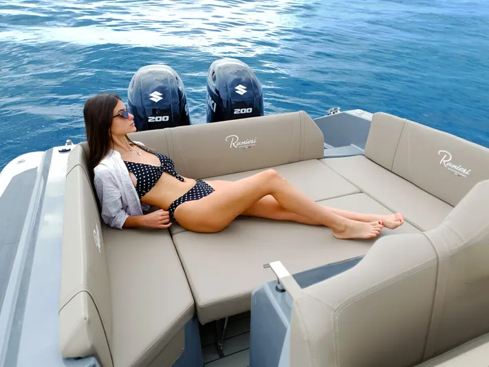 Yacht Photos Pics Woman relaxing on Ranieri CAYMAN 28 EXECUTIVE boat, 2025 model, with twin Suzuki 200 engines.