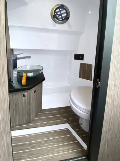  Yacht Photos Pics 2025 Ranieri CAYMAN 28 EXECUTIVE boat bathroom with modern fixtures and wood accents.