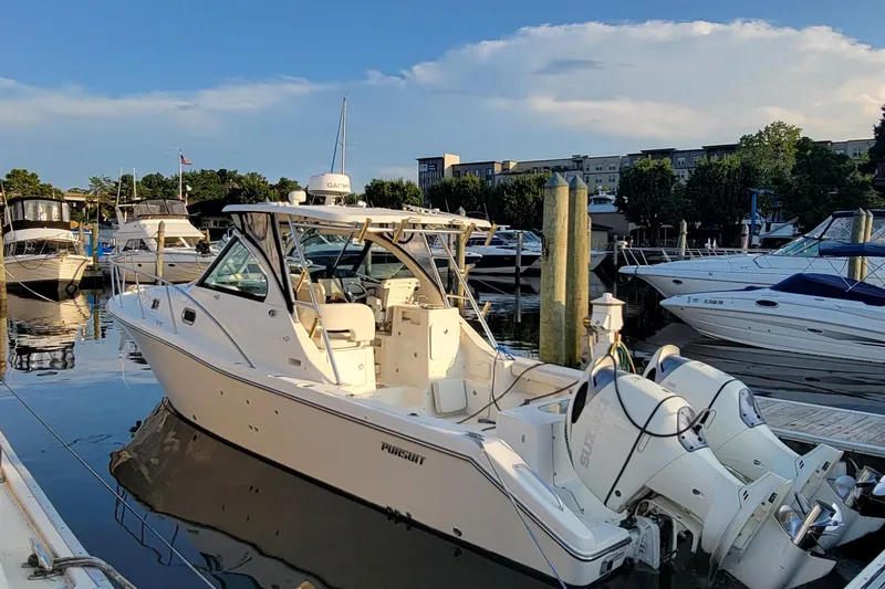  Yacht Photos Pics 2007 Pursuit OS 335 Offshore boat docked at marina, surrounded by other vessels.