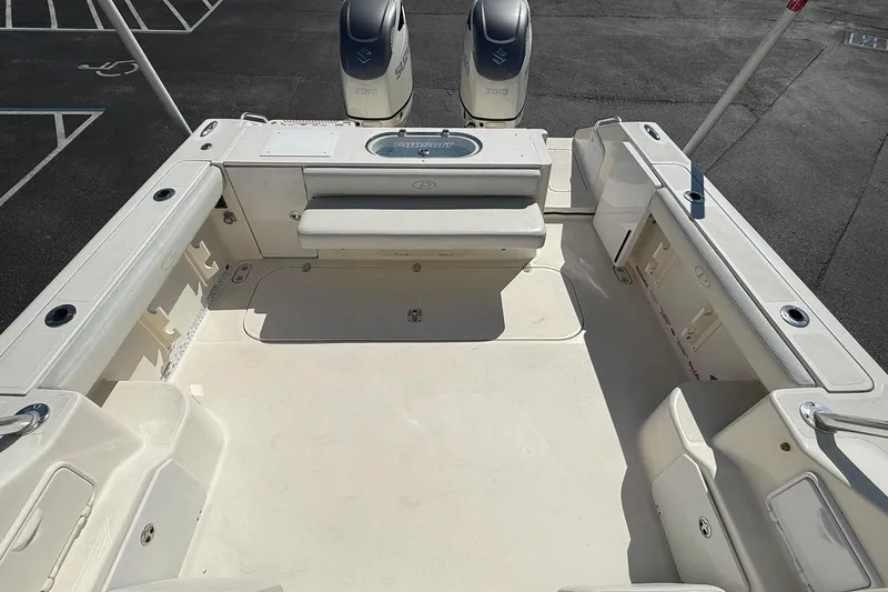  Yacht Photos Pics 2007 Pursuit OS 335 Offshore boat deck with twin engines, spacious seating, and storage compartments.