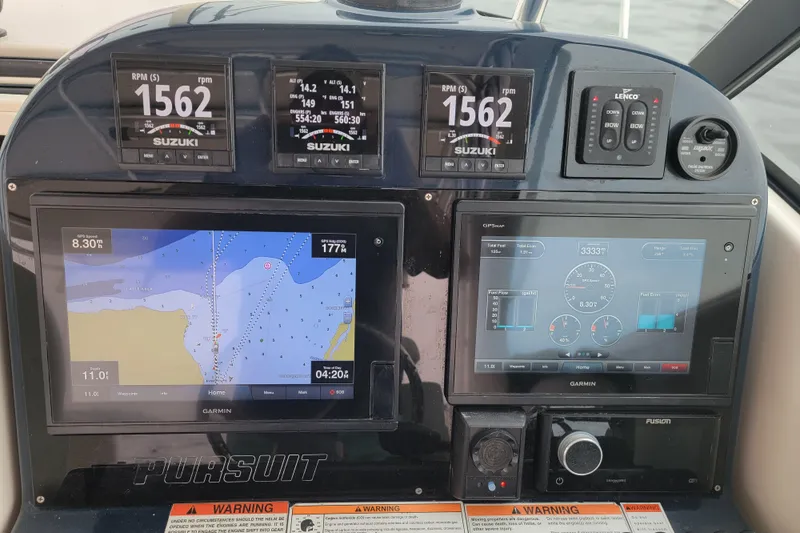  Yacht Photos Pics Dashboard of a 2007 Pursuit OS 335 Offshore boat with navigation and engine displays.