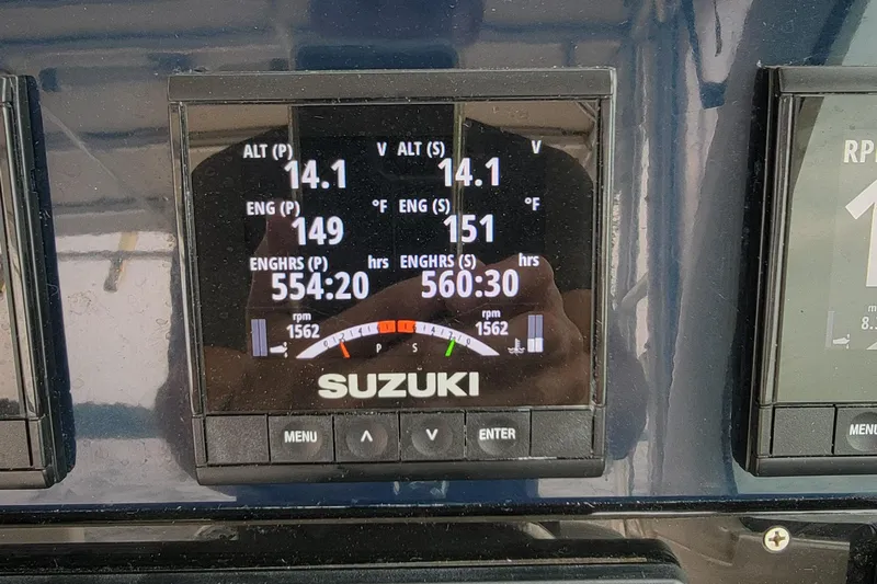  Yacht Photos Pics Suzuki engine display on 2007 Pursuit OS 335 Offshore boat, showing voltage and engine hours.