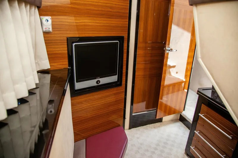  Yacht Photos Pics Interior of 2009 Marquis 500 Sport Coupe with wood paneling and a mounted TV.