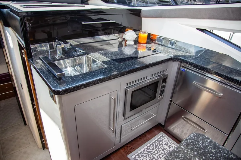  Yacht Photos Pics Luxurious kitchen in 2009 Marquis 500 Sport Coupe yacht with modern appliances and sleek design.
