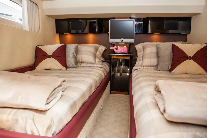  Yacht Photos Pics Luxurious twin cabin in 2009 Marquis 500 Sport Coupe yacht, featuring elegant bedding and modern amenities.