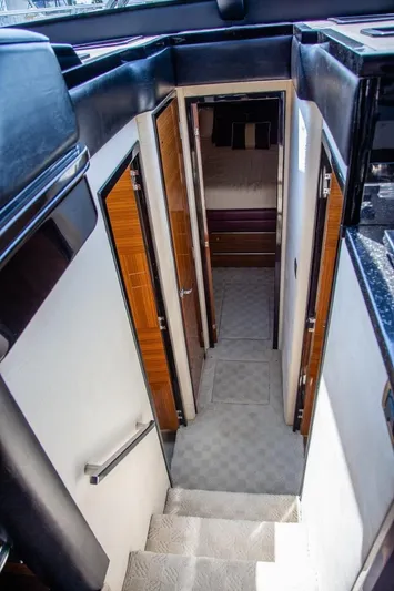  Yacht Photos Pics Interior view of 2009 Marquis 500 Sport Coupe yacht, featuring a narrow hallway and stairs.