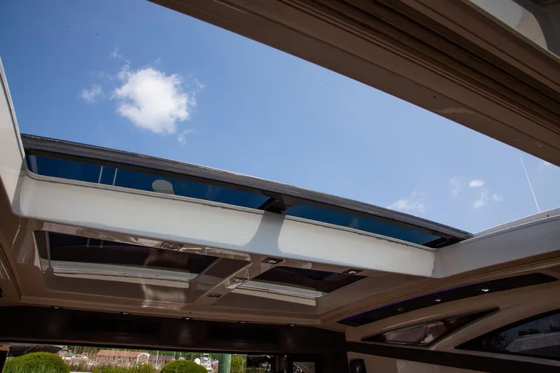  Yacht Photos Pics Open sunroof of 2009 Marquis 500 Sport Coupe yacht under clear blue sky.