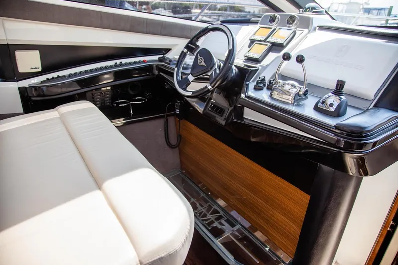  Yacht Photos Pics Interior of 2009 Marquis 500 Sport Coupe yacht, featuring sleek dashboard and steering wheel.