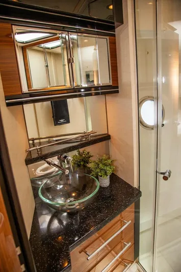  Yacht Photos Pics Luxurious bathroom in 2009 Marquis 500 Sport Coupe yacht with glass sink and modern fixtures.