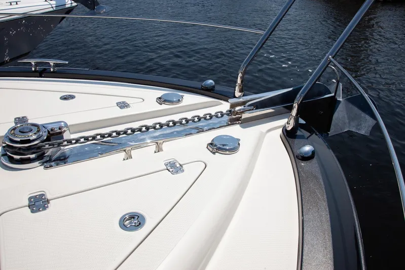  Yacht Photos Pics Bow of 2009 Marquis 500 Sport Coupe yacht with anchor chain and water view.