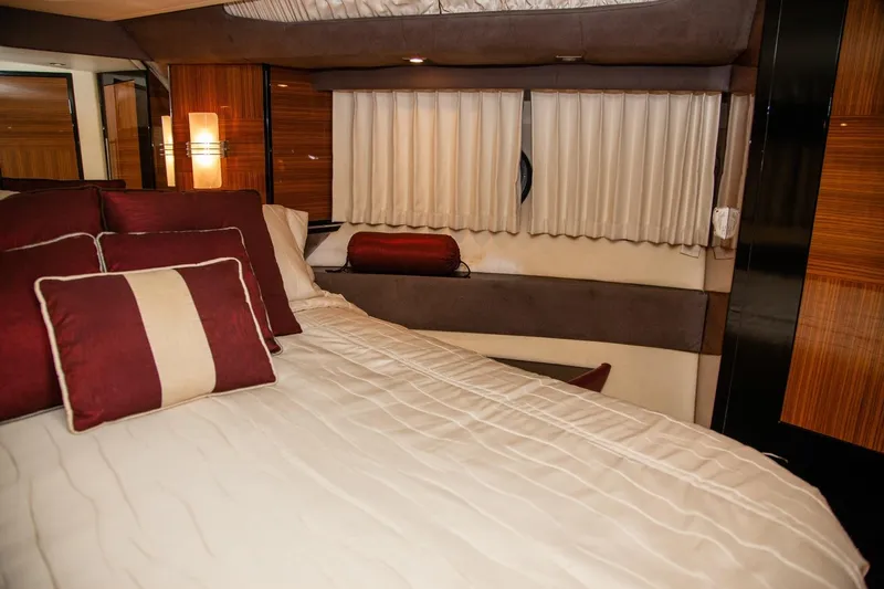  Yacht Photos Pics Luxurious interior of 2009 Marquis 500 Sport Coupe with elegant bedding and wood accents.