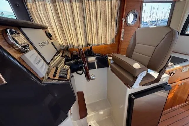 Evangaline Yacht Photos Pics Interior of 2022 Ranger Tugs R-25 boat with helm station and captain's chair.