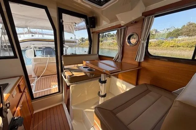 Evangaline Yacht Photos Pics Interior of 2022 Ranger Tugs R-25 boat with wood accents and seating area.