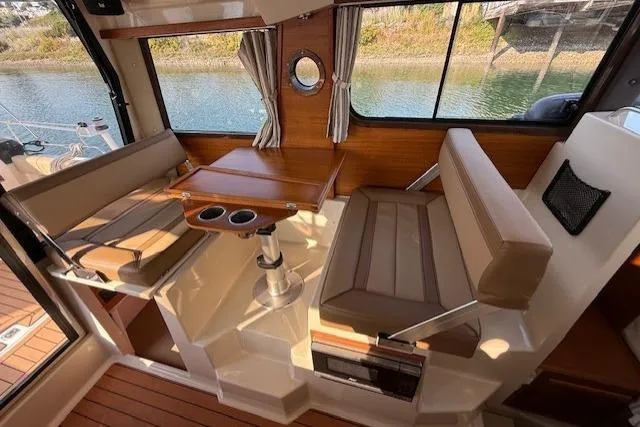 Evangaline Yacht Photos Pics 2022 Ranger Tugs R-25 interior with seating, table, and window view.