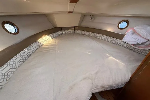 Evangaline Yacht Photos Pics 2022 Ranger Tugs R-25 cabin interior with cozy bed and porthole windows.