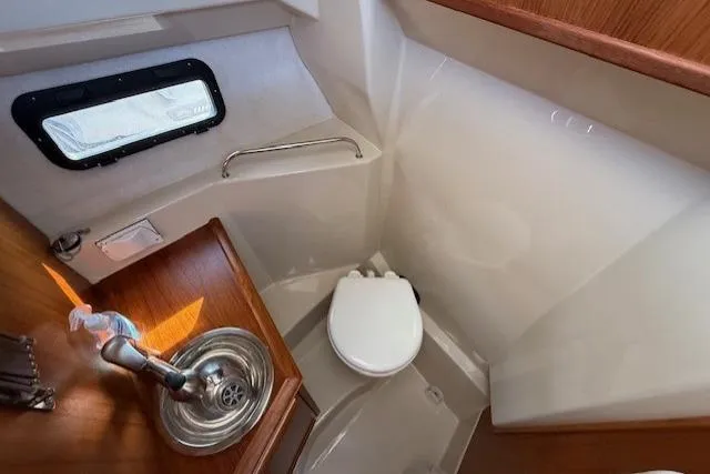 Evangaline Yacht Photos Pics 2022 Ranger Tugs R-25 boat bathroom with sink, toilet, and window.