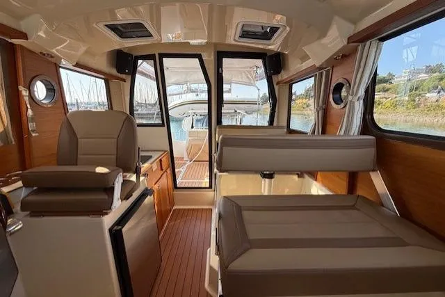 Evangaline Yacht Photos Pics Interior of 2022 Ranger Tugs R-25 boat with seating and wood accents.