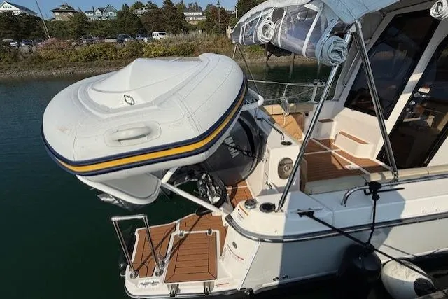 Evangaline Yacht Photos Pics 2022 Ranger Tugs R-25 with inflatable boat on davit system, docked in a marina.