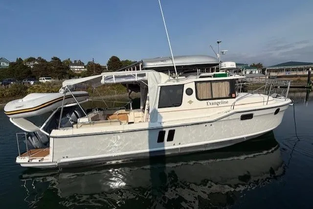 Evangaline Yacht Photos Pics 2022 Ranger Tugs R-25 boat docked, featuring sleek design and spacious deck.