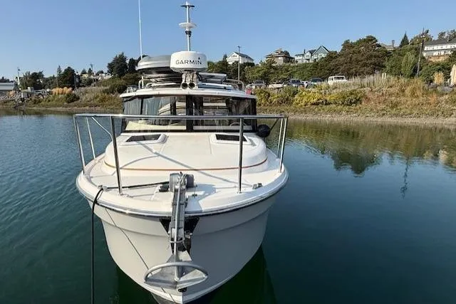 Evangaline Yacht Photos Pics 2022 Ranger Tugs R-25 boat docked on calm water with scenic background.