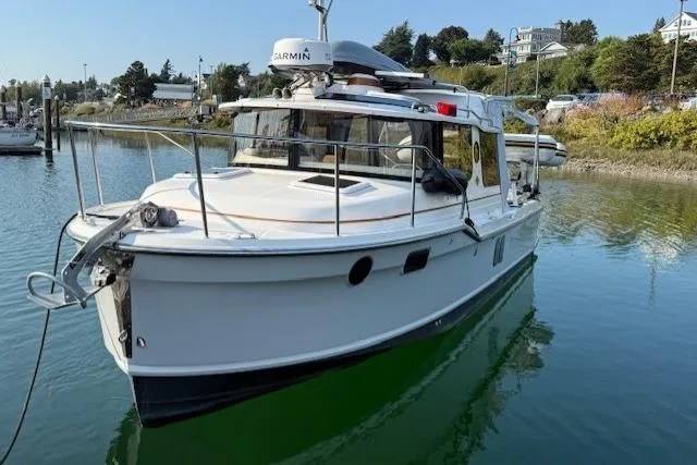 Evangaline Yacht Photos Pics 2022 Ranger Tugs R-25 boat docked in a serene marina setting.